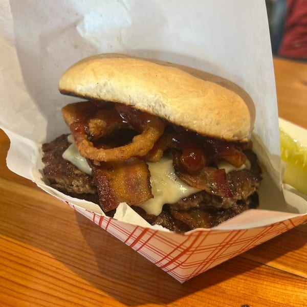 A Clover Leaf on Franklin double cheeseburger with bacon, onion rings, and BBQ sauce.