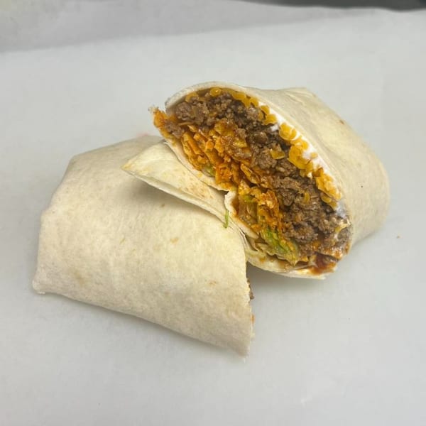 A Clover Leaf on Franklin burrito, cut in half, revealing ground beef, cheese, and lettuce.